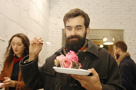 A visitor with a portion of the edible sculpture