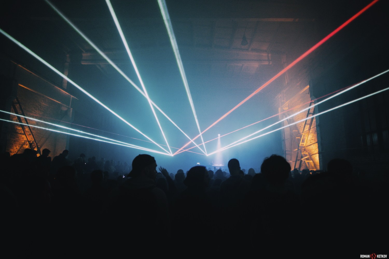 Lights above the night-time dance floor · SLEEK