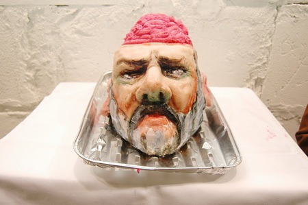 Edible portrait with pink cream on a white plinth